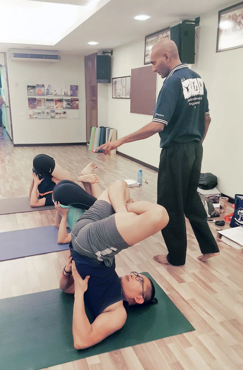 Master Manisekaran guiding students in a yoga class